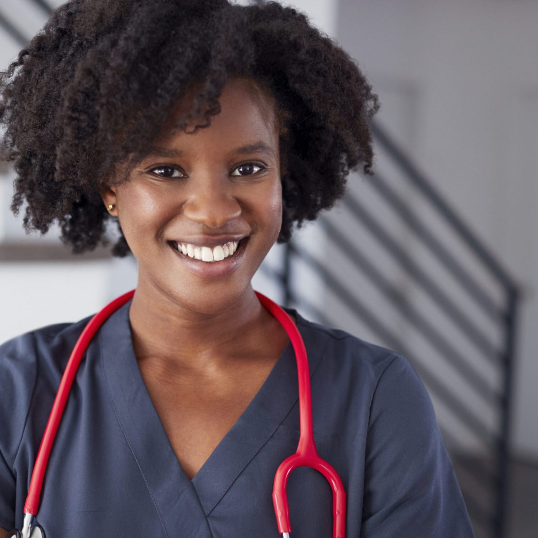 Portrait Of Female Nurse Wearing Scrubs In Hospital Portrait Of Female Nurse Wearing Scrubs In Hospital